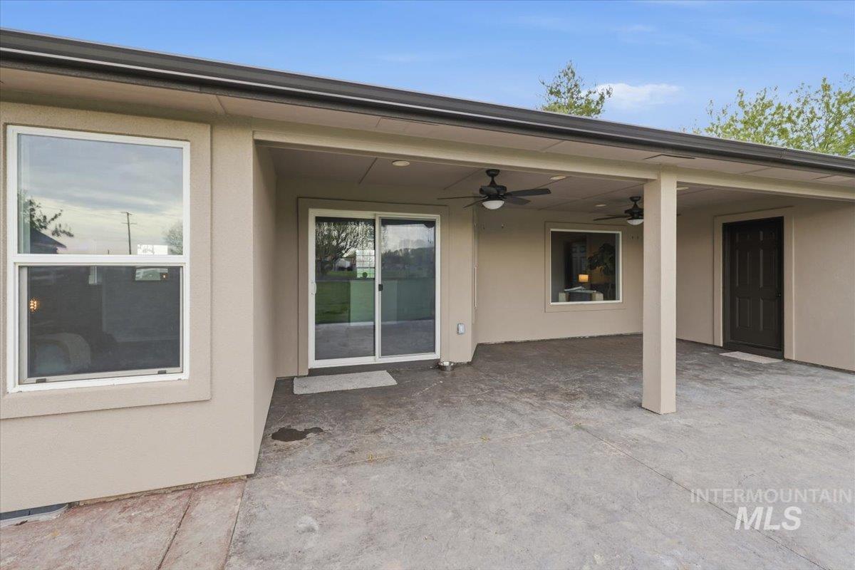25022 Tumbleweed Road Middleton, ID 83644 - Photo 31 of 41 Entrance to property with a patio area, ceiling fan, and stucco siding