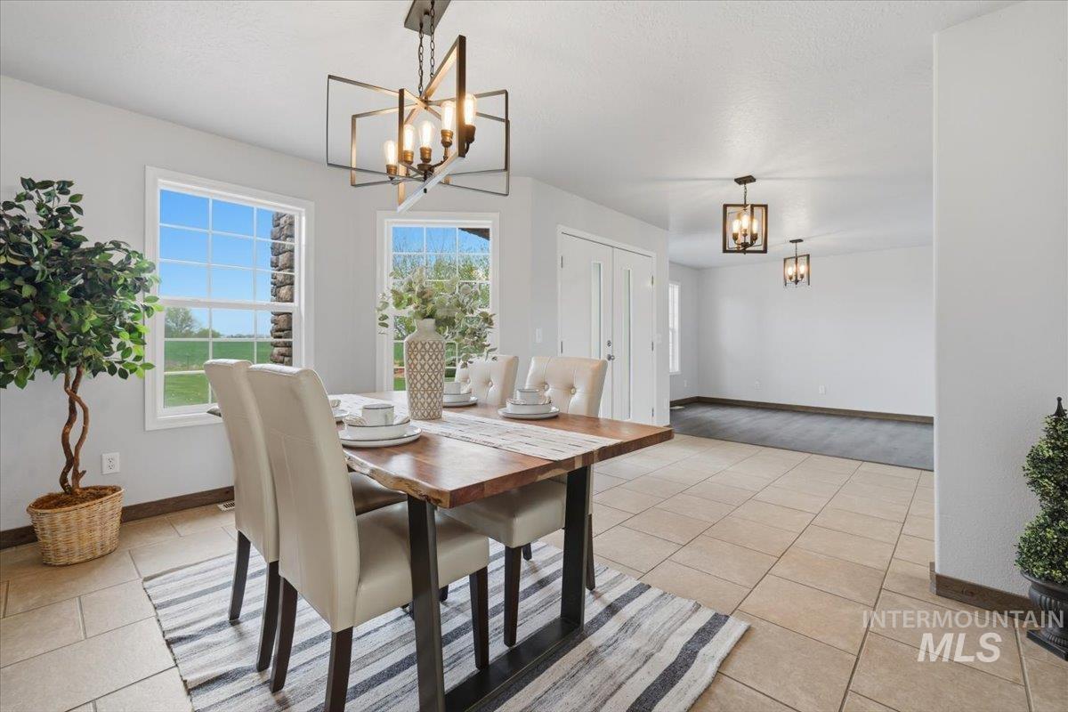 25022 Tumbleweed Road Middleton, ID 83644 - Photo 5 of 41 Dining room with suspended lighting and light tile patterned floors