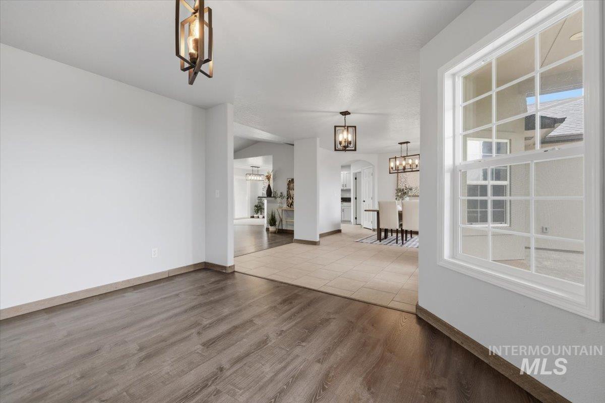25022 Tumbleweed Road Middleton, ID 83644 - Photo 7 of 41 Unfurnished dining area with dark wood-style floors and arched walkways