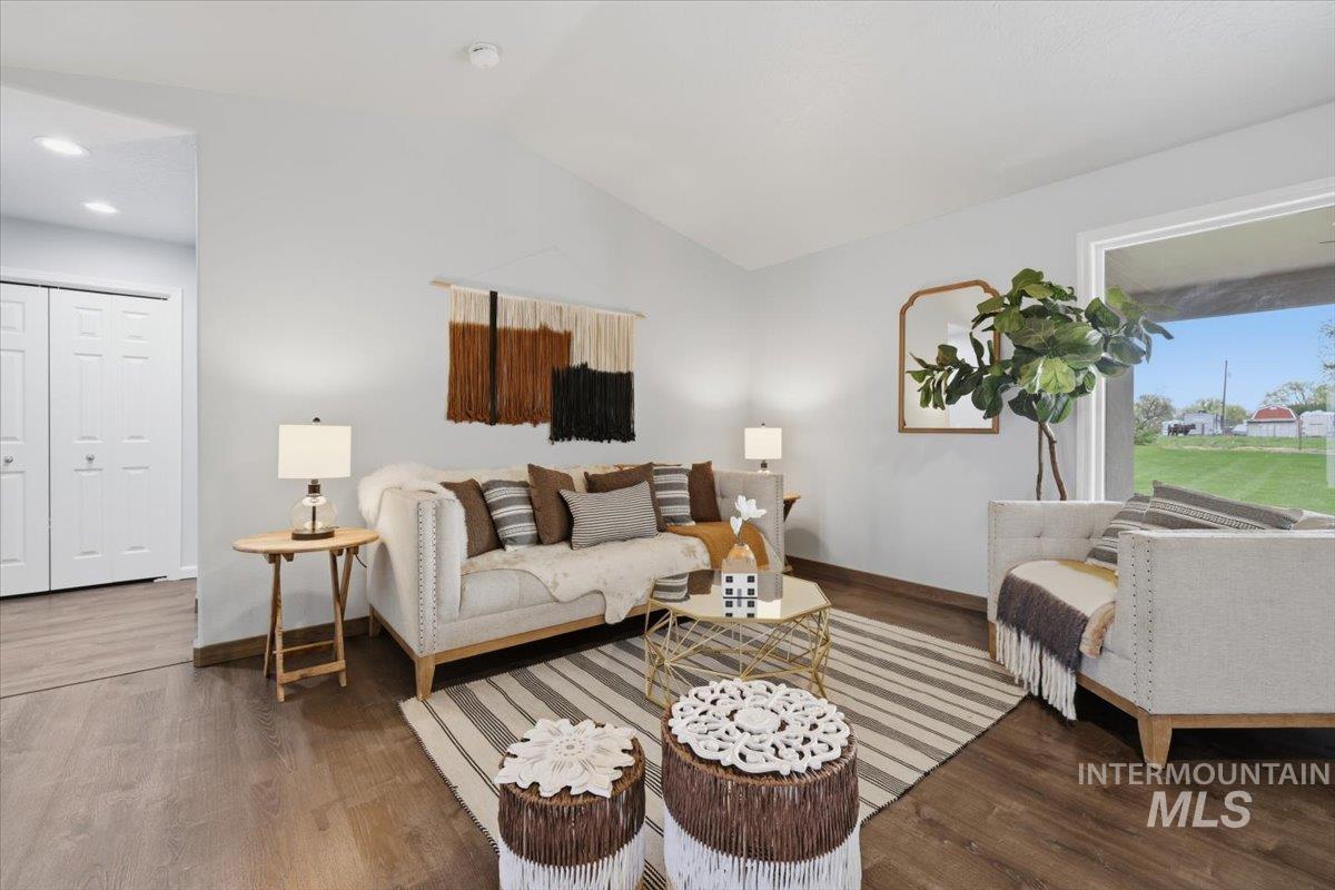 25022 Tumbleweed Road Middleton, ID 83644 - Photo 9 of 41 Living room featuring wood finished floors and lofted ceiling