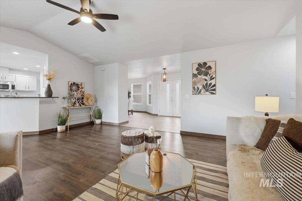 25022 Tumbleweed Road Middleton, ID 83644 - Photo 10 of 41 Living room featuring a ceiling fan, lofted ceiling, dark wood-type flooring, and recessed lighting