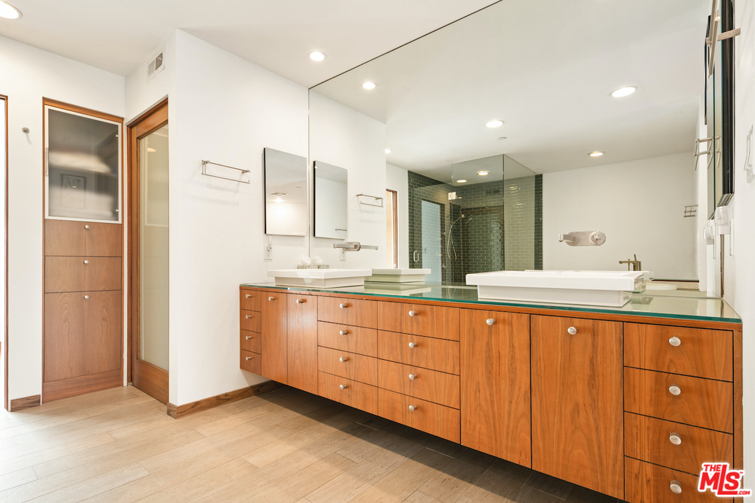 512 Brooks Avenue, Unit 4 Venice, CA 90291 - Photo 16 of 25 a spacious bathroom with a granite countertop sink mirror and cabinets