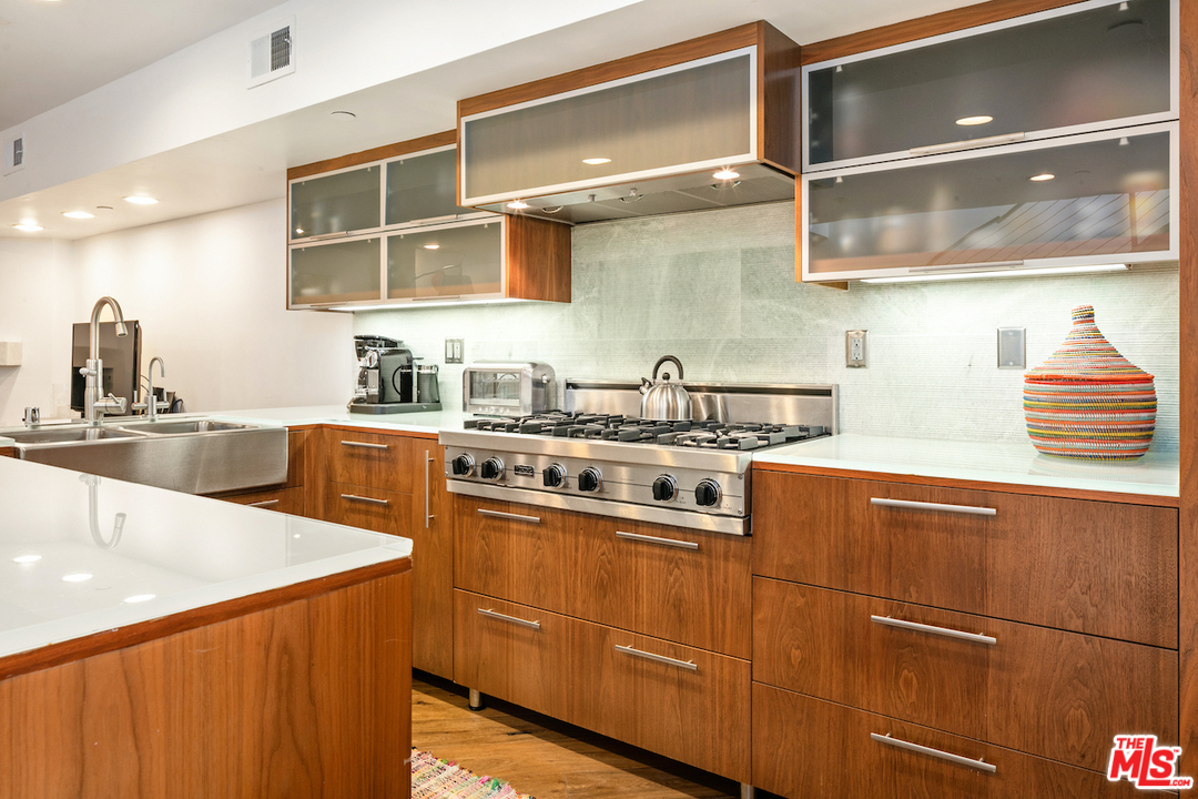 512 Brooks Avenue, Unit 4 Venice, CA 90291 - Photo 7 of 25 a kitchen with stainless steel appliances granite countertop a sink stove and cabinets