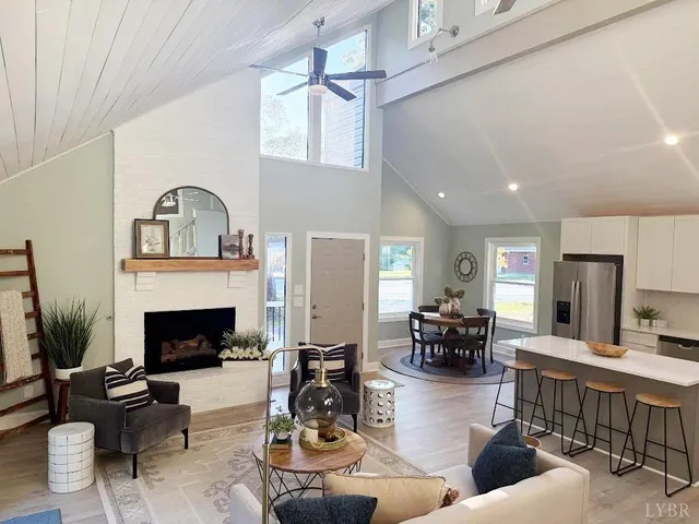 a living room with furniture a fireplace and a table