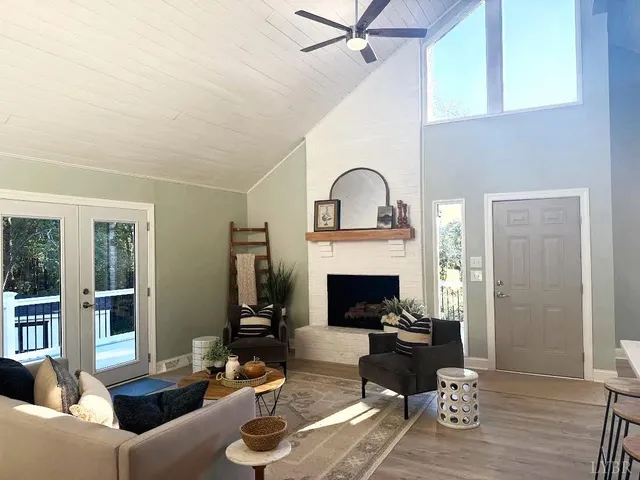 a kitchen with stainless steel appliances a white table chairs and a refrigerator