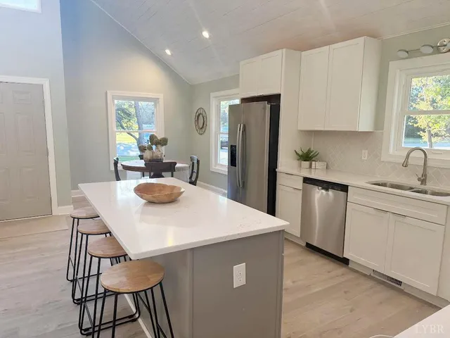 a dining room with furniture and a large window