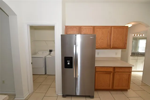 a kitchen with a sink window and cabinets