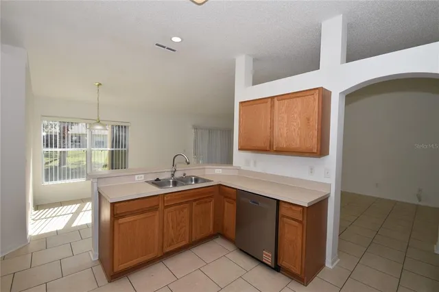 a kitchen with stainless steel appliances granite countertop a stove microwave and sink