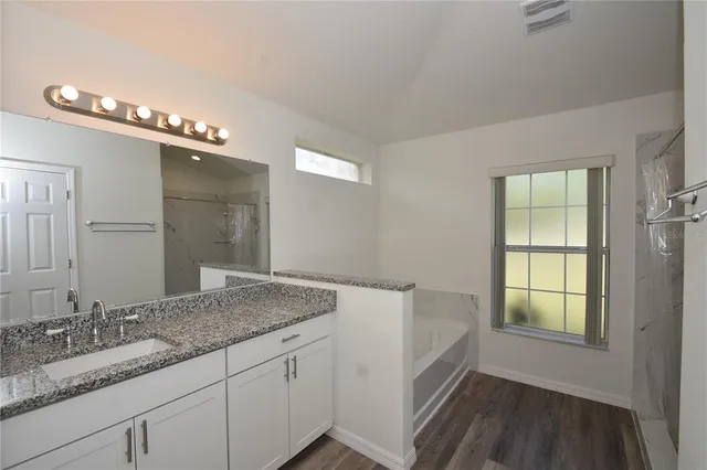 a bathroom with a bathtub and a sink