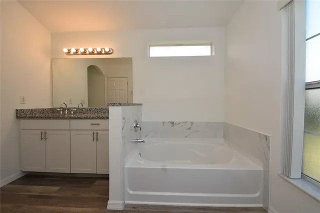 a bathroom with a double vanity sink and a mirror