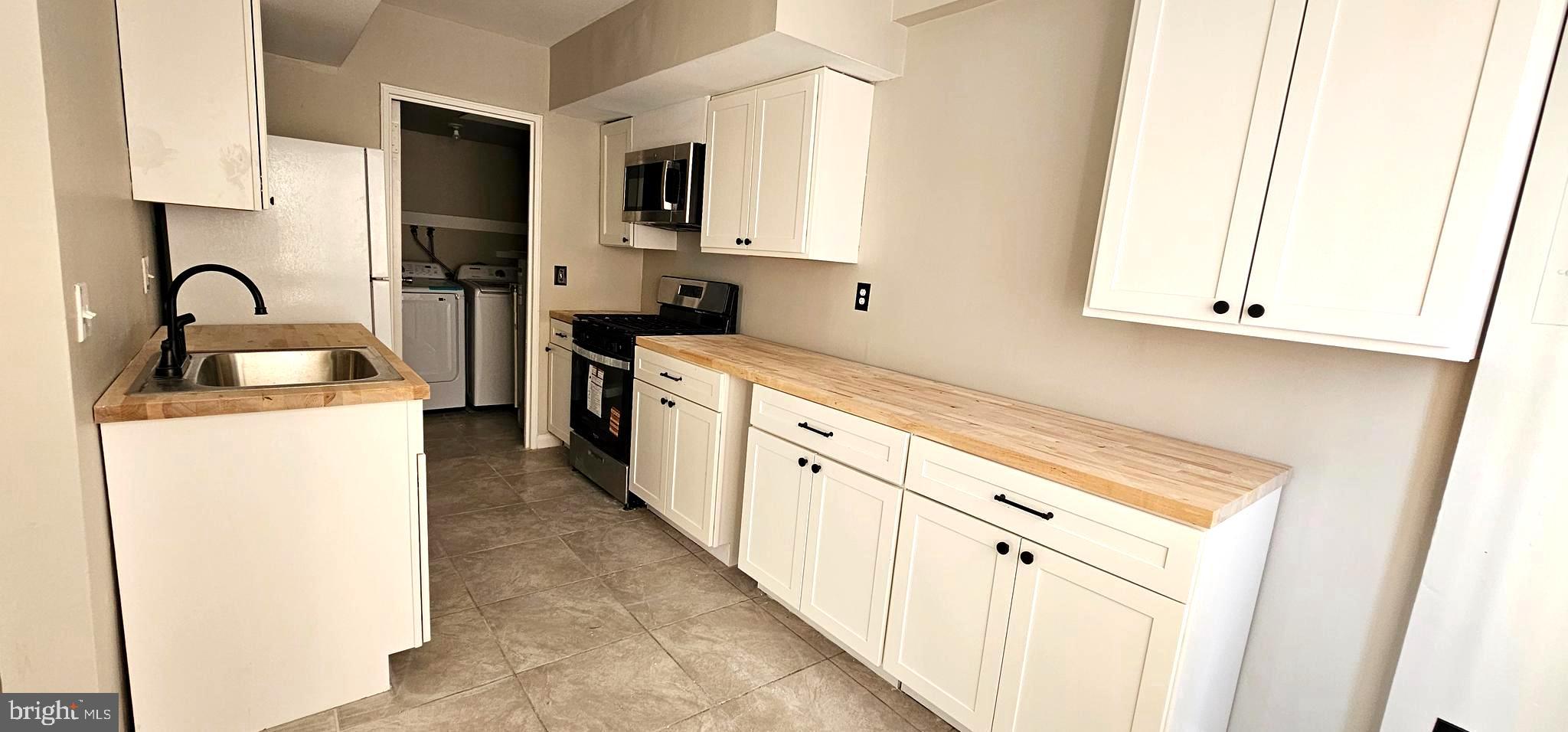 501 Germantown Court Warminster, PA 18974 - Photo 4 of 12 a kitchen with sink a microwave and cabinets