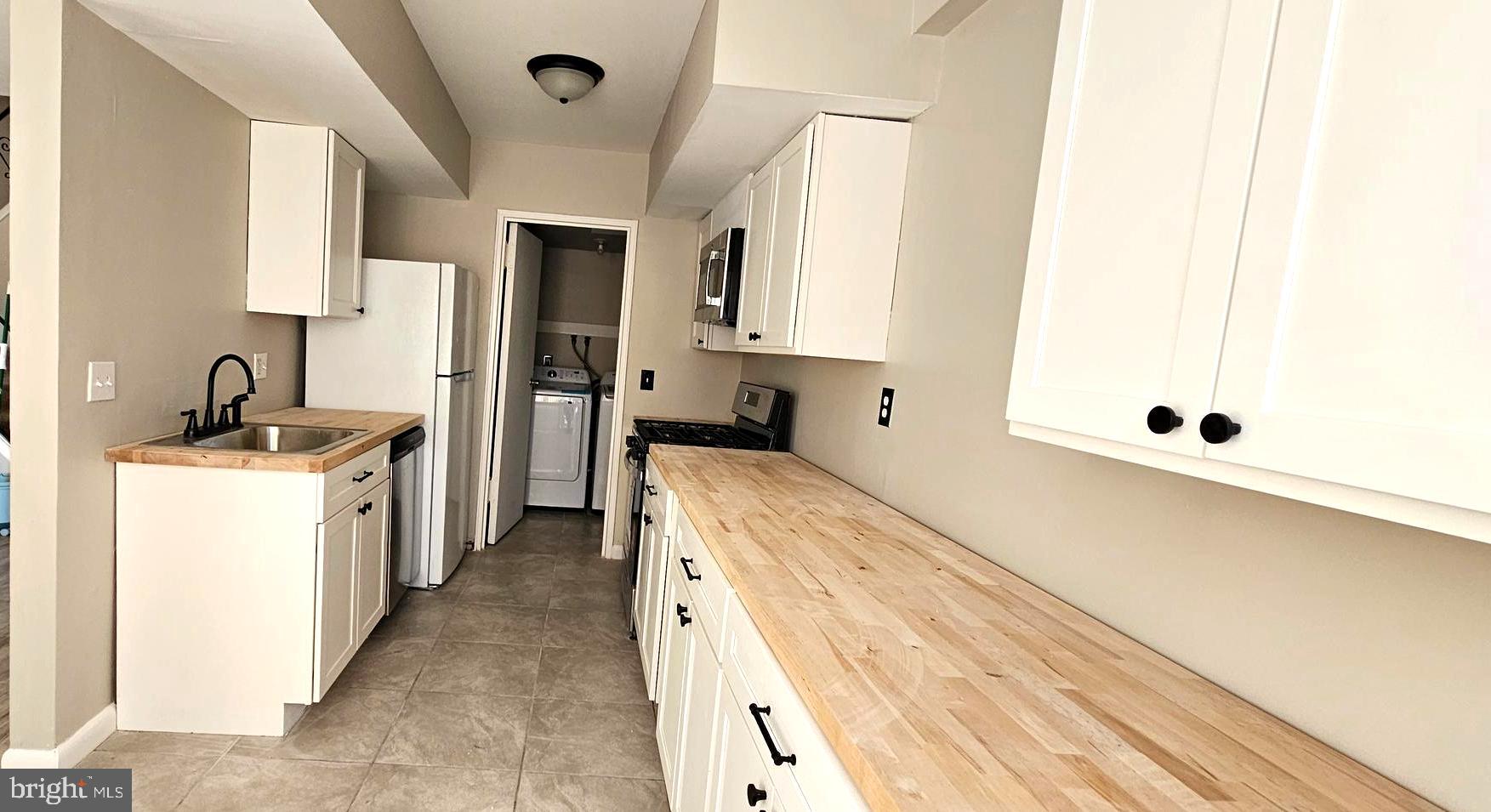 501 Germantown Court Warminster, PA 18974 - Photo 5 of 12 a kitchen with a sink and a refrigerator