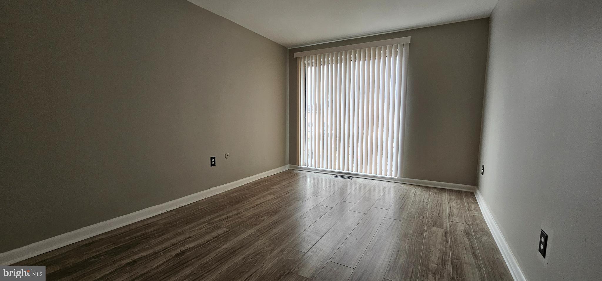 501 Germantown Court Warminster, PA 18974 - Photo 10 of 12 a view of an empty room with wooden floor and a window