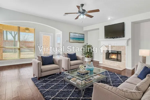 a living room with furniture a flat screen tv and a fireplace