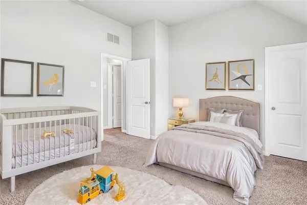a bedroom with a bed and a baby crib