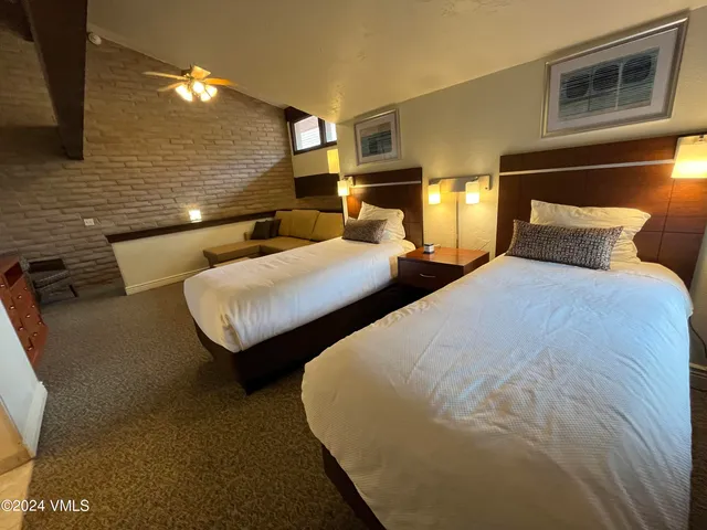 a bedroom with two beds and painted walls