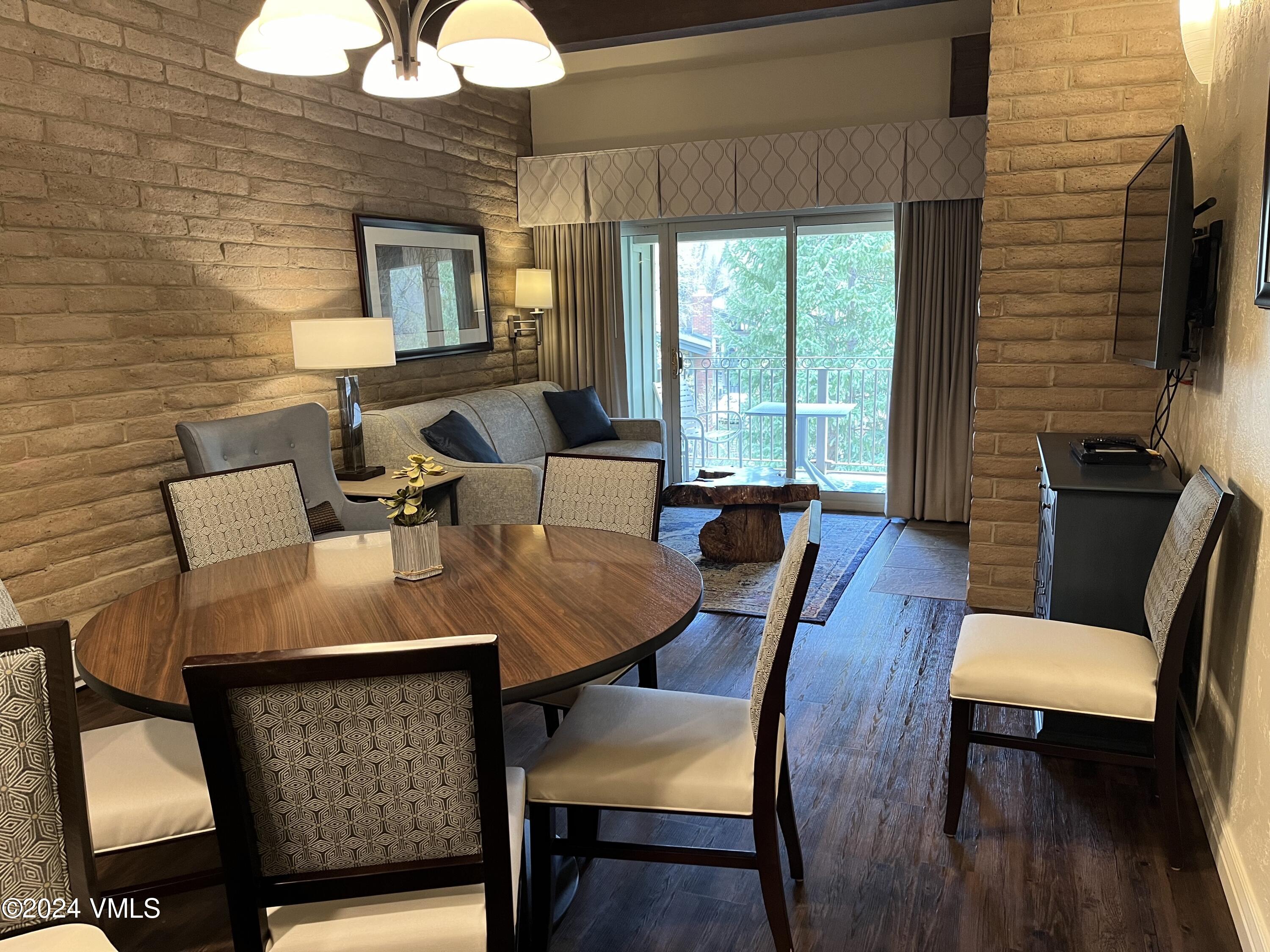 1020 Vail View Drive, Unit 341221 Vail, CO 81657 - Photo 2 of 26 a view of a dining room with furniture window and wooden floor