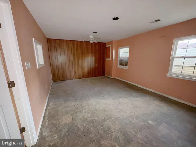 an empty room with windows and closet