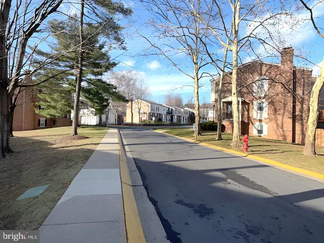 a view of street with houses on both side of street