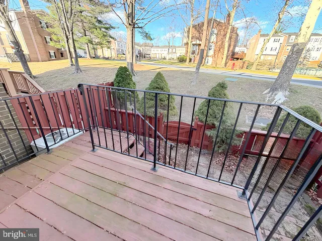 a view of a balcony with wooden floor and fence
