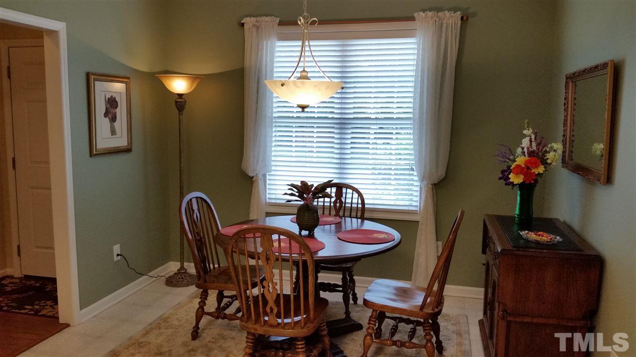5425 Neuse Forest Road Raleigh, NC 27616 - Photo 3 of 25 a view of a dining room with furniture and chandelier