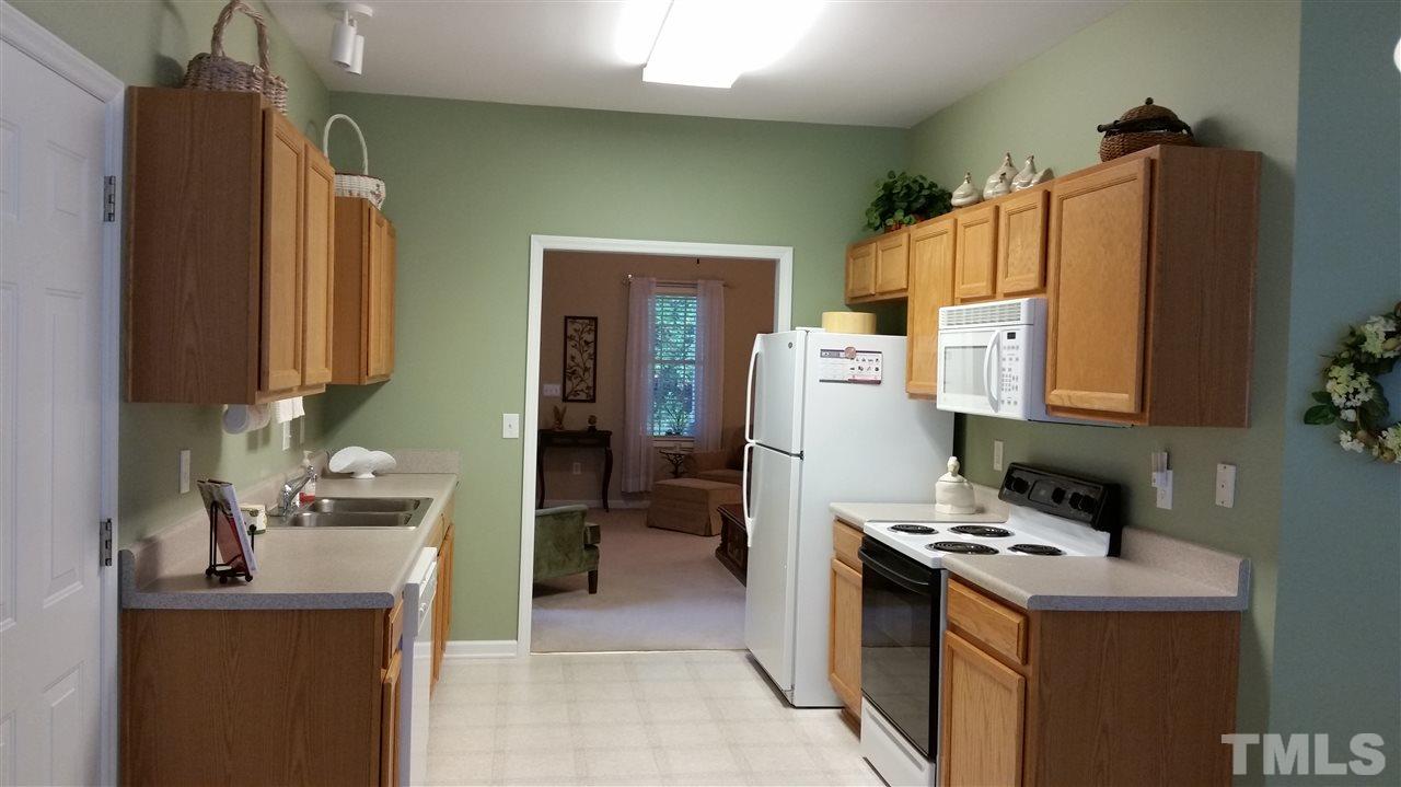 5425 Neuse Forest Road Raleigh, NC 27616 - Photo 4 of 25 a kitchen with a refrigerator and a stove