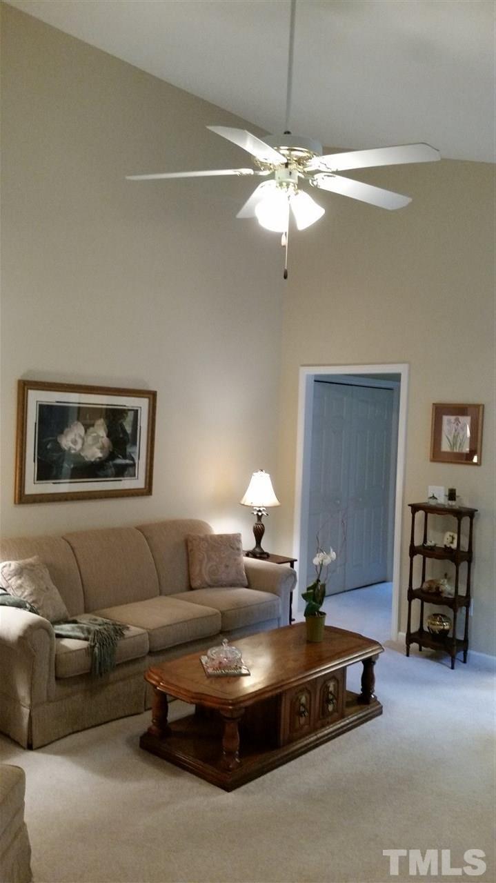 5425 Neuse Forest Road Raleigh, NC 27616 - Photo 7 of 25 a living room with furniture and a chandelier