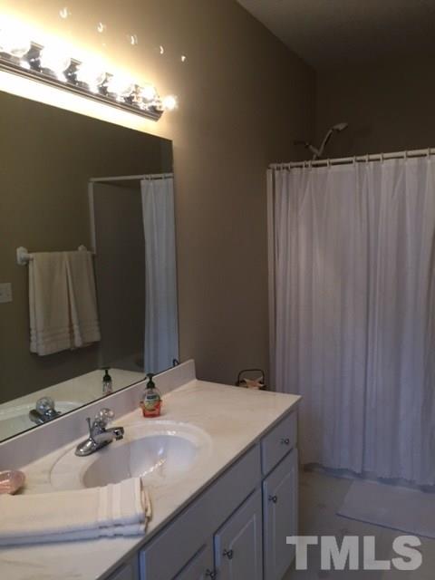 5425 Neuse Forest Road Raleigh, NC 27616 - Photo 10 of 25 a bathroom with a sink and a mirror