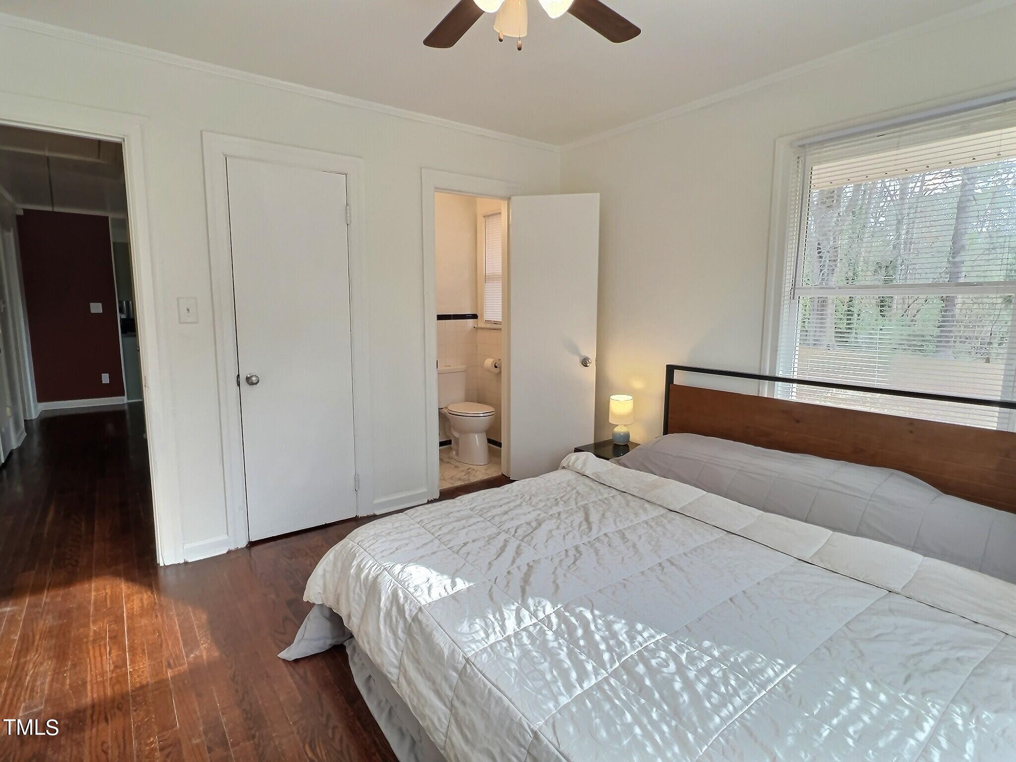 717 St George Road Raleigh, NC 27610 - Photo 14 of 32 a bedroom with a bed and a chandelier
