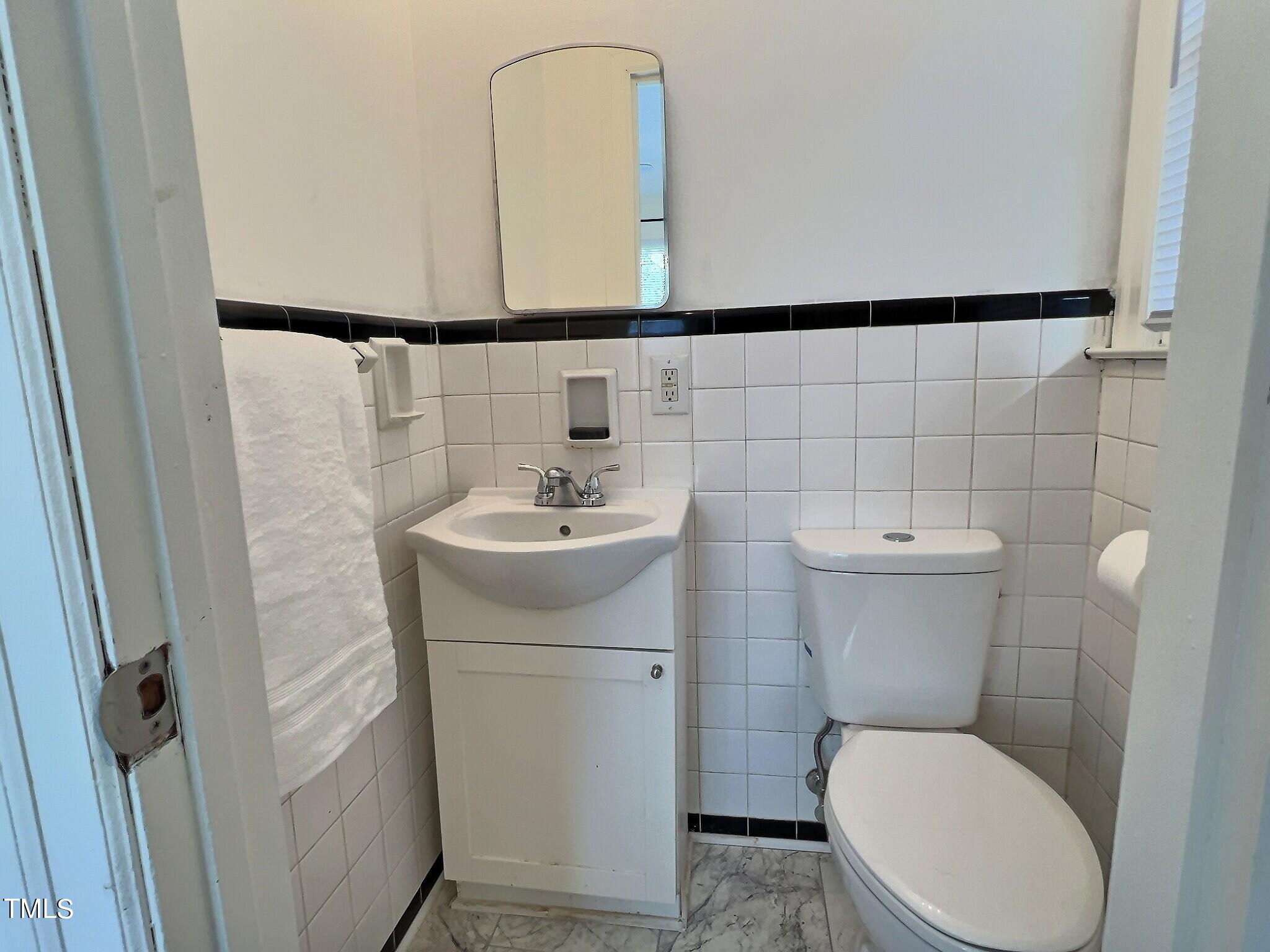 717 St George Road Raleigh, NC 27610 - Photo 15 of 32 a bathroom with a toilet sink and mirror