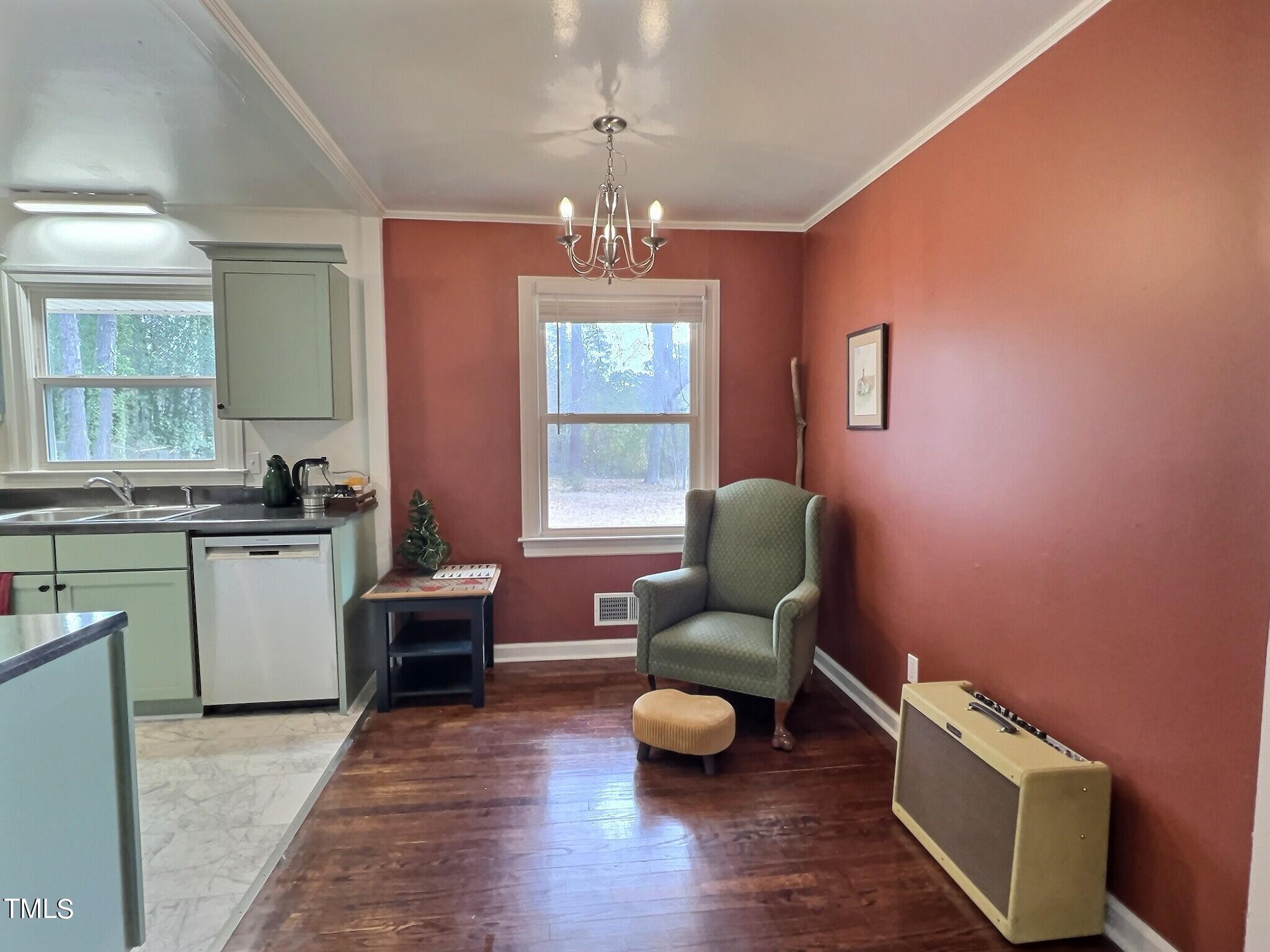 717 St George Road Raleigh, NC 27610 - Photo 9 of 32 a living room with furniture and a wooden floor