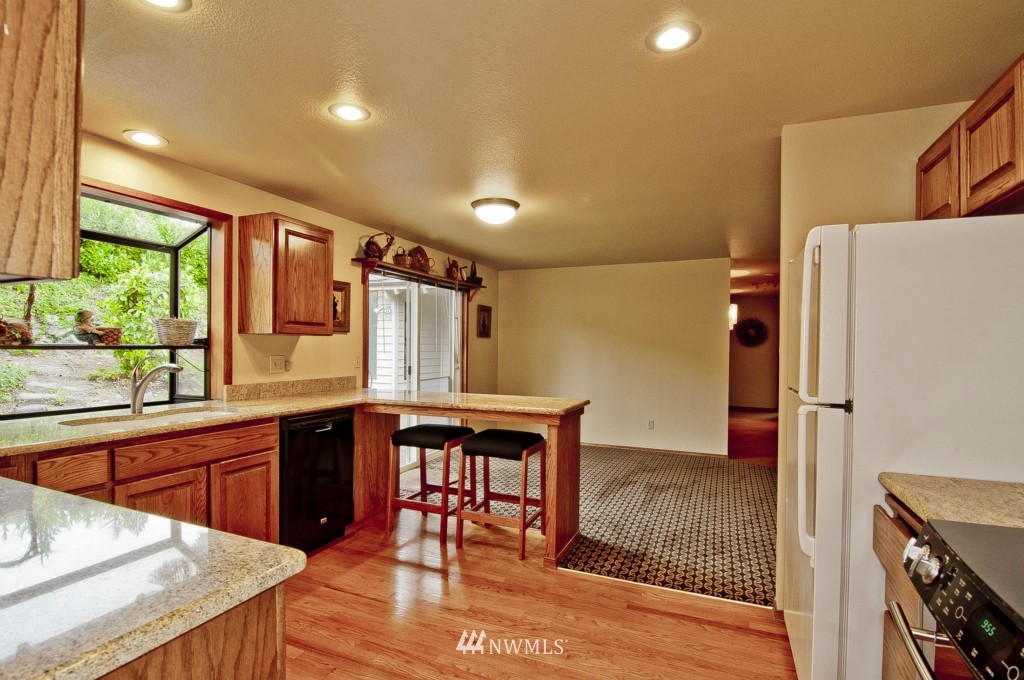 22324 4th Avenue Southeast Bothell, WA 98021 - Photo 3 of 24 a kitchen with stainless steel appliances granite countertop a sink and a refrigerator