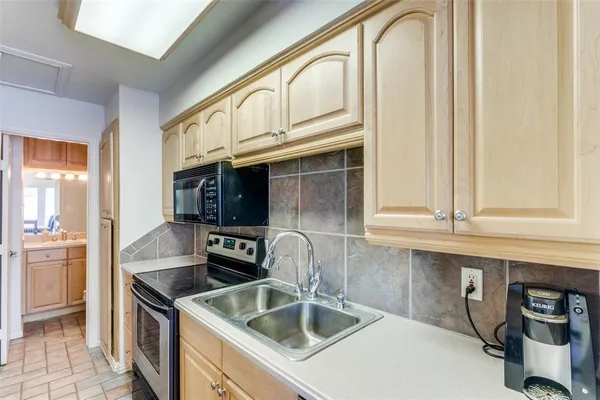 a kitchen with stainless steel appliances granite countertop a sink and cabinets