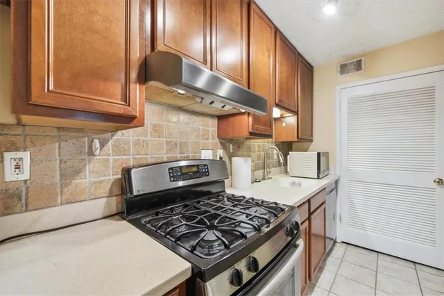 a kitchen with a stove and a sink