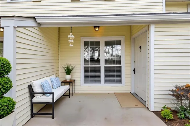 a view of a patio with table and chairs and potted plants