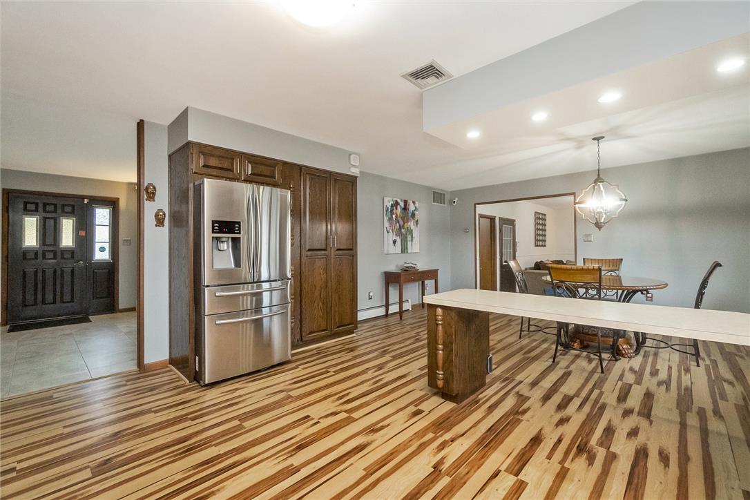 5728 Pheasant Road Bethlehem, PA 18017 - Photo 15 of 39 Richly grained wood flooring flows seamlessly from the kitchen into the adjacent dining area.
