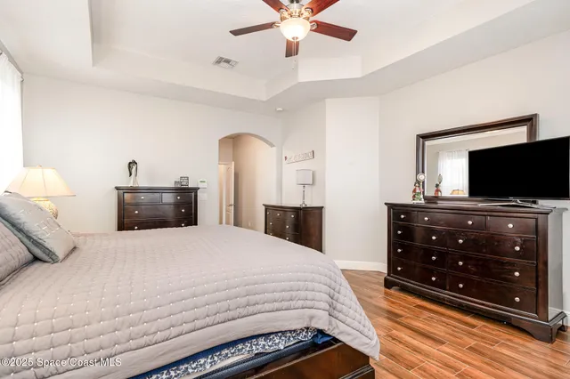 a bedroom with a bed and a flat tv screen