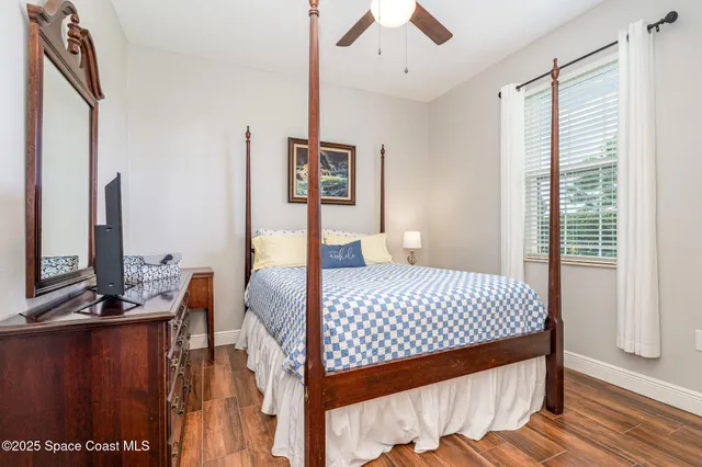 a bedroom with a bed and wooden floor