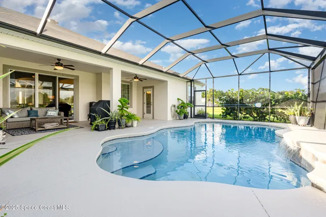 a view of a house with a big yard and large trees