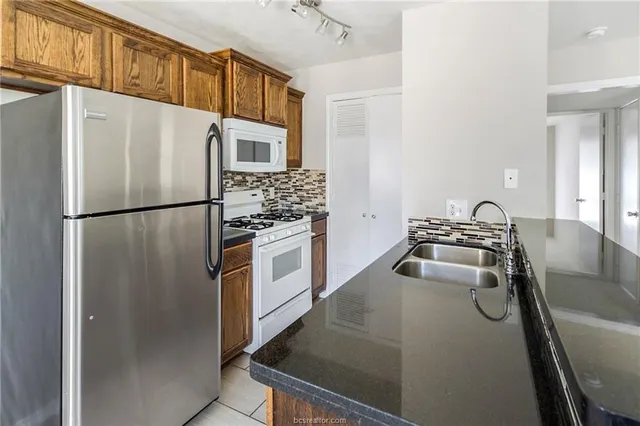 a kitchen with a sink stove and cabinets