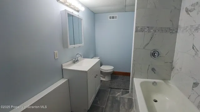 a bathroom with a sink a toilet and bathtub