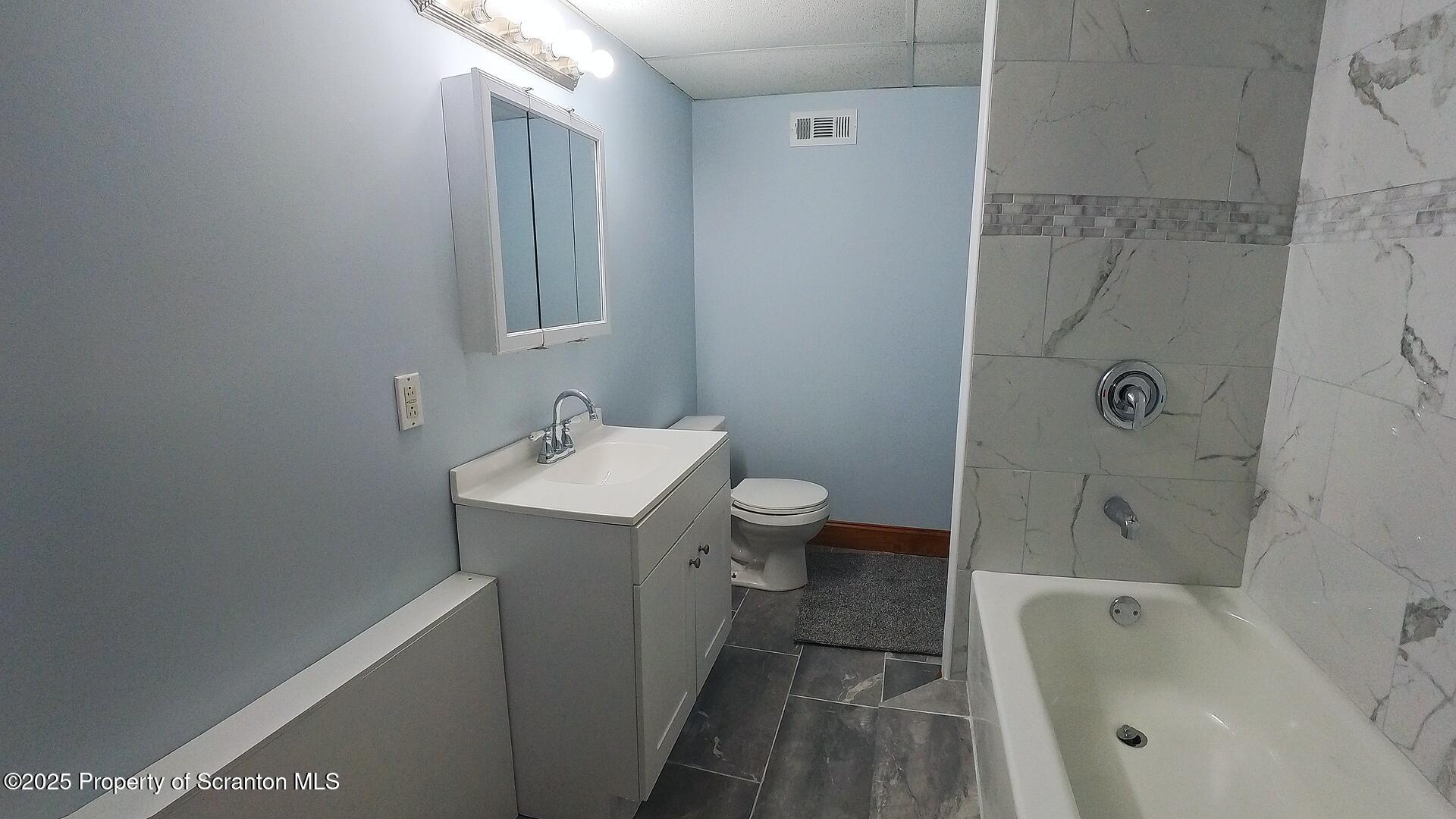 193 South Cedar Street Hazleton, PA 18201 - Photo 17 of 27 a bathroom with a sink a toilet and bathtub