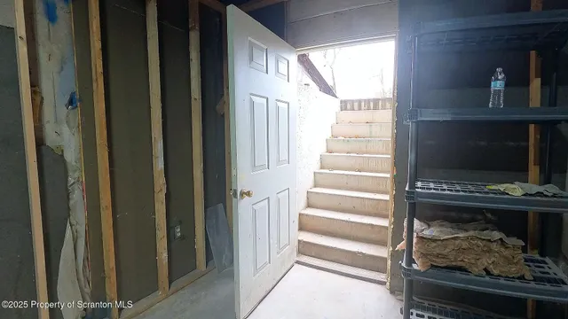 a view of a livingroom with wooden floor and a window