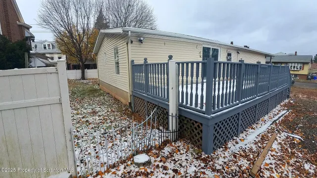 a view of a backyard with a wooden fence