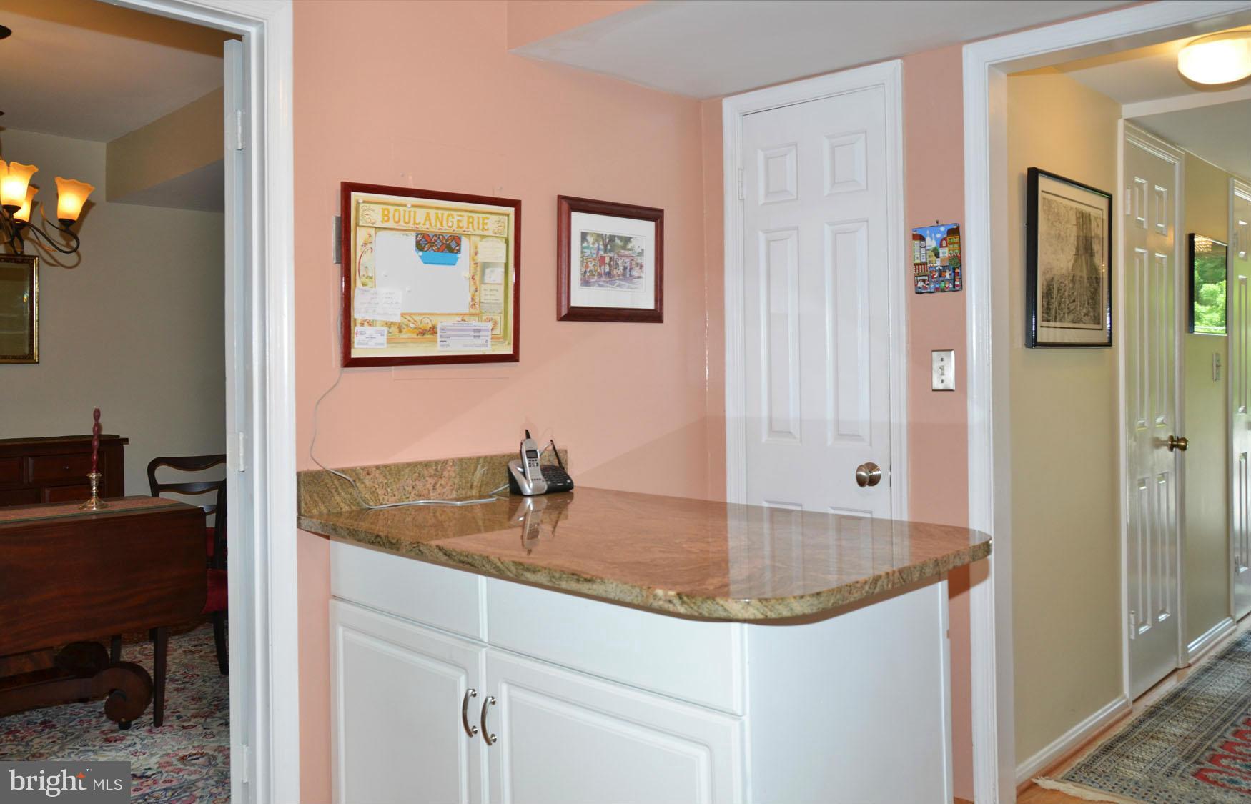 6607 Hillandale Road, Unit 89 Chevy Chase, MD 20815 - Photo 12 of 30 a bathroom with a granite countertop sink and a bathtub