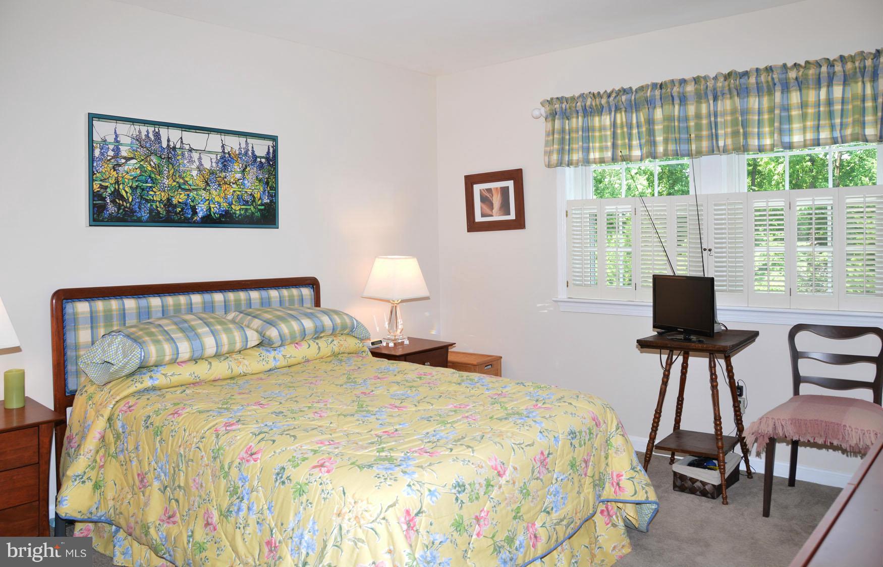 6607 Hillandale Road, Unit 89 Chevy Chase, MD 20815 - Photo 16 of 30 a bedroom with a bed and wooden floor