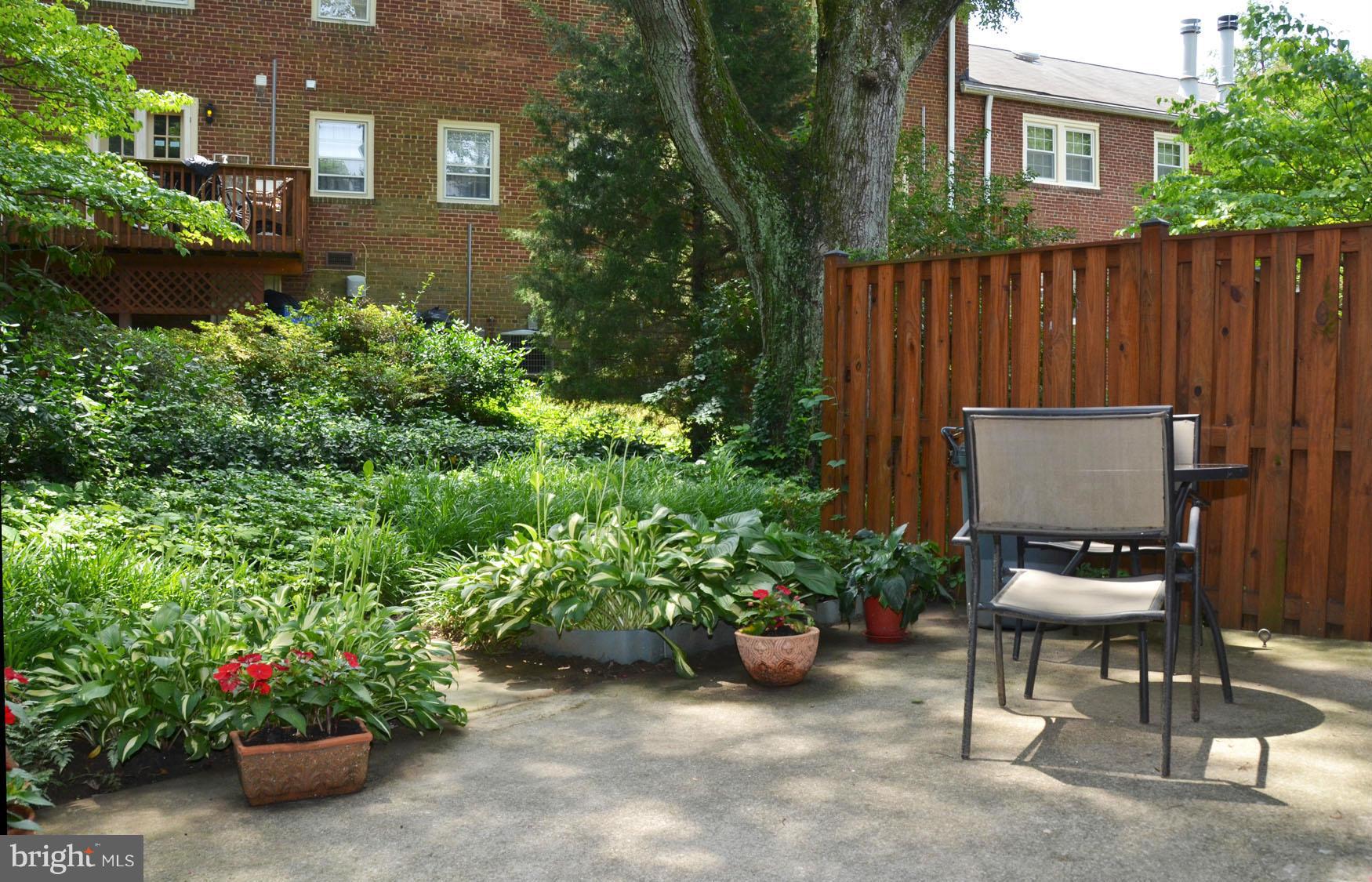 6607 Hillandale Road, Unit 89 Chevy Chase, MD 20815 - Photo 28 of 30 a view of a chair and table in a back yard of a house