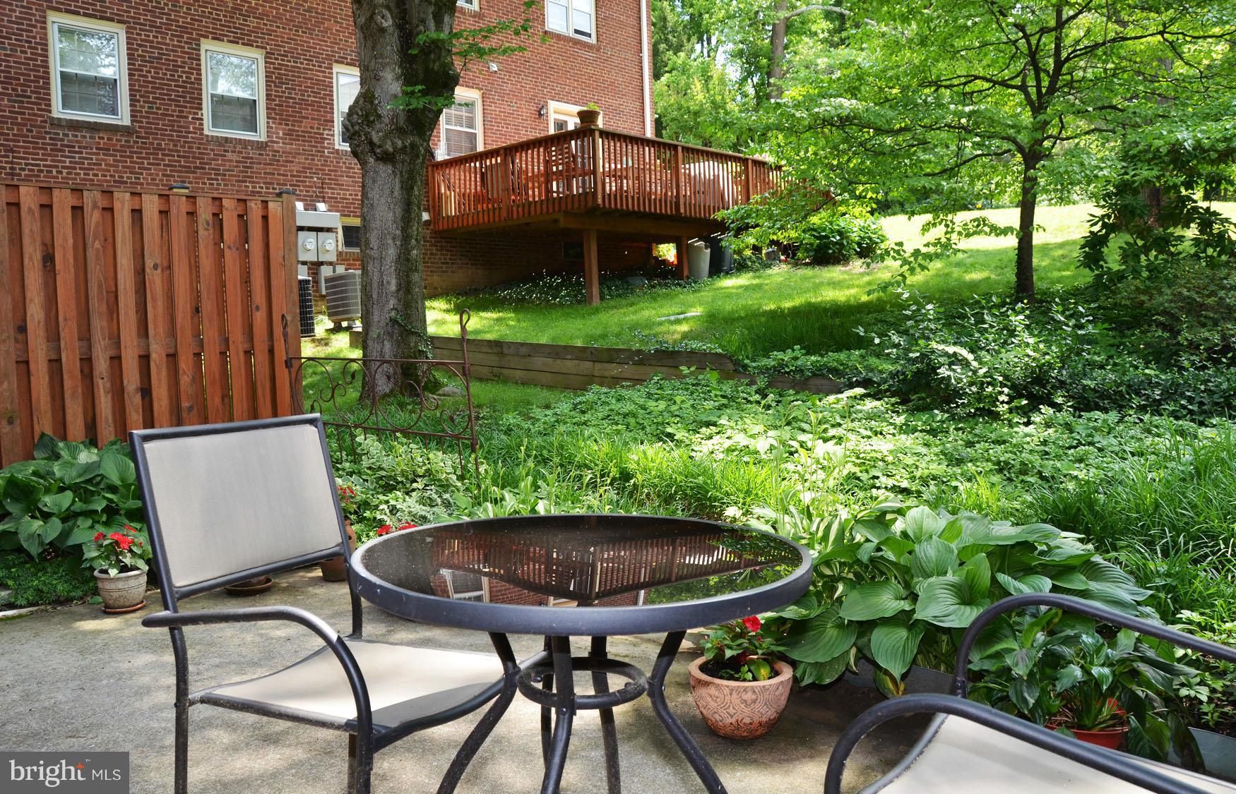 6607 Hillandale Road, Unit 89 Chevy Chase, MD 20815 - Photo 5 of 30 a view of a chairs and table in backyard of the house