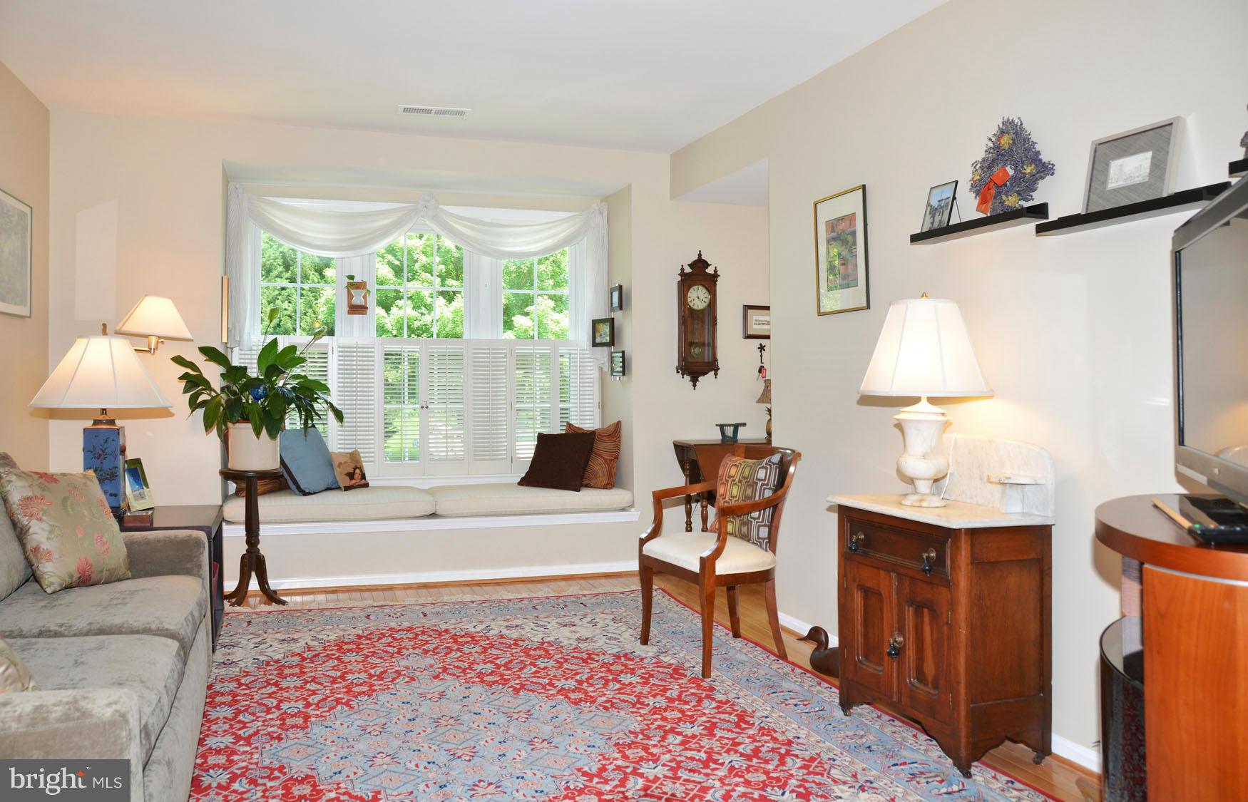 6607 Hillandale Road, Unit 89 Chevy Chase, MD 20815 - Photo 6 of 30 a living room with furniture a table and a potted plant