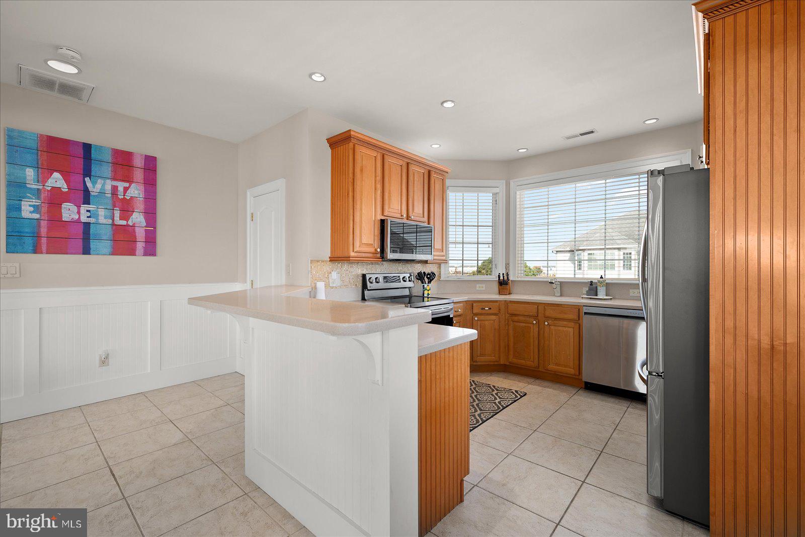 12901 Old Bridge Road, Unit PH8 2 Ocean City, MD 21842 - Photo 13 of 79 a kitchen with a sink cabinets and window
